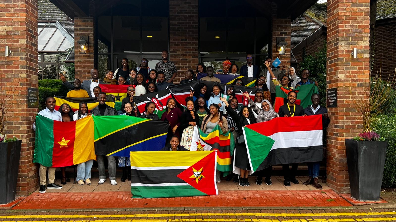 Young Africans holding flags from across the continent