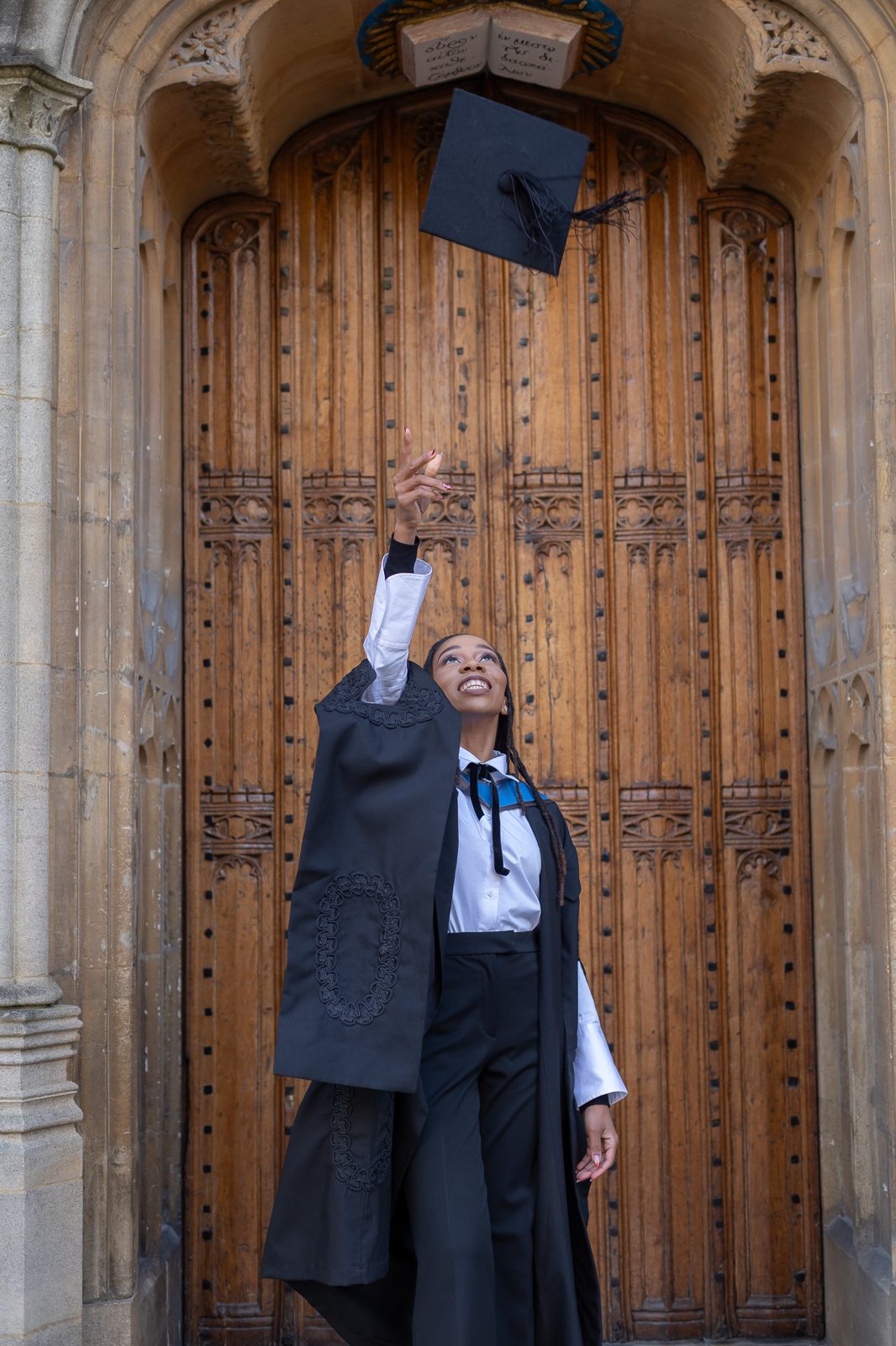 Mantate tossing her graduation cap at Oxford