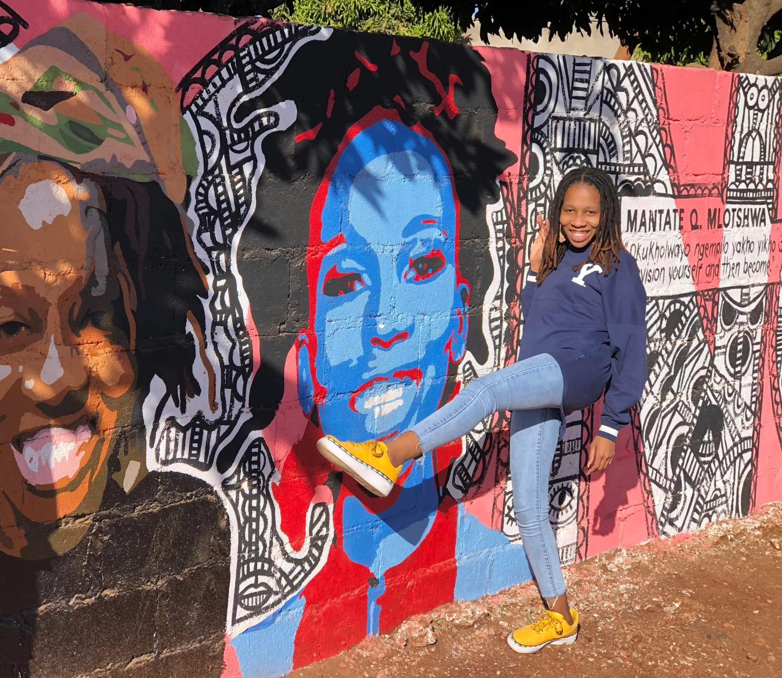 Mantate beside the Bulawayo mural painted in her honour